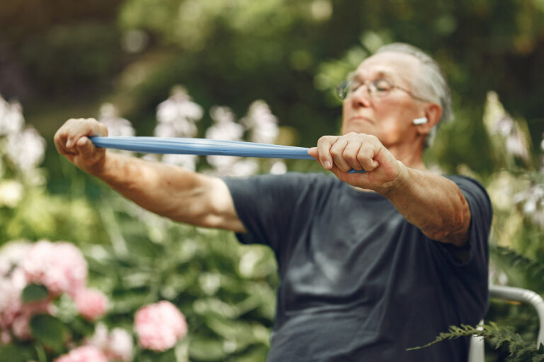 Portrait of happy handsome older man in a park